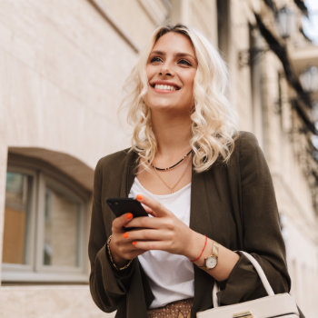 happy confident blonde girl walks the street