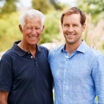 portrait of joyful mature son and elderly father