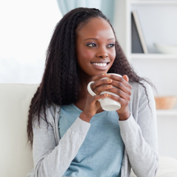 smiling african american woman holding cup